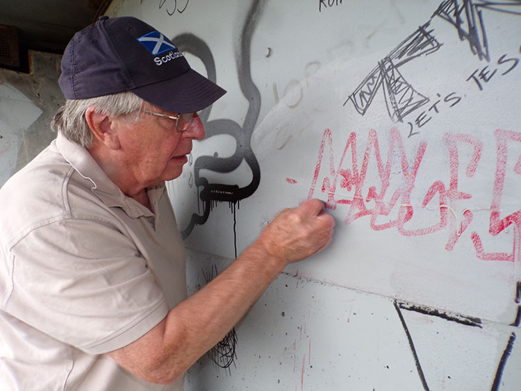 Julian Baldwin trials a Brillo-pad to clean off paint